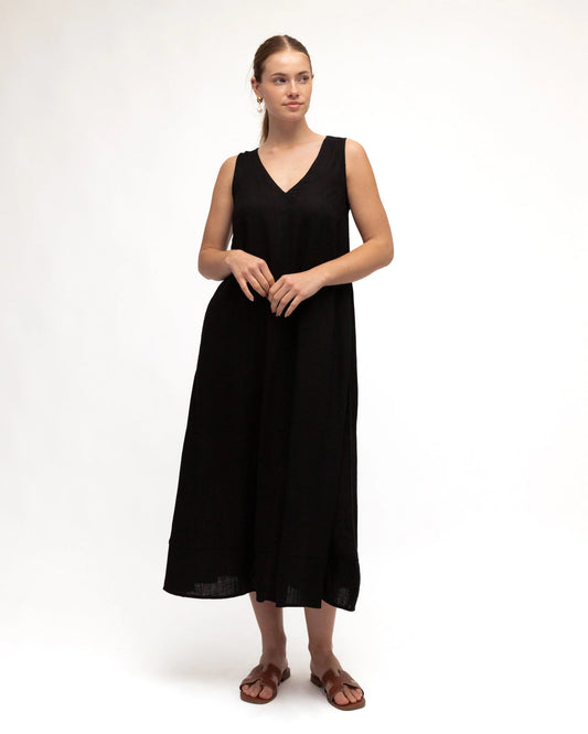 Woman wearing a black sleeveless dress on a white background