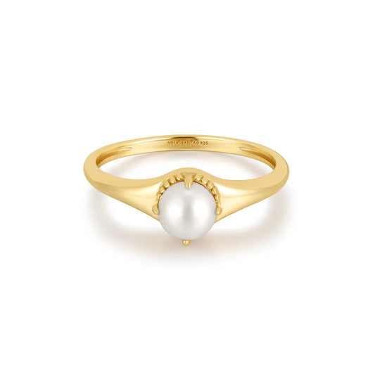 Gold ring with a pearl on a white background